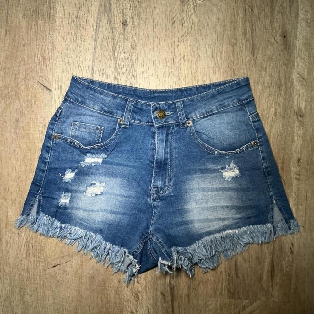 blue denim mini skirt with frayed hem and button fly. Size: S